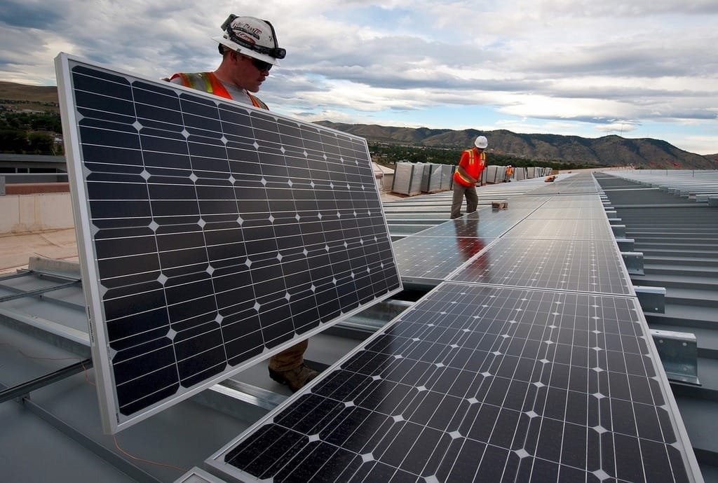 Solar technician assessing a rooftop property
